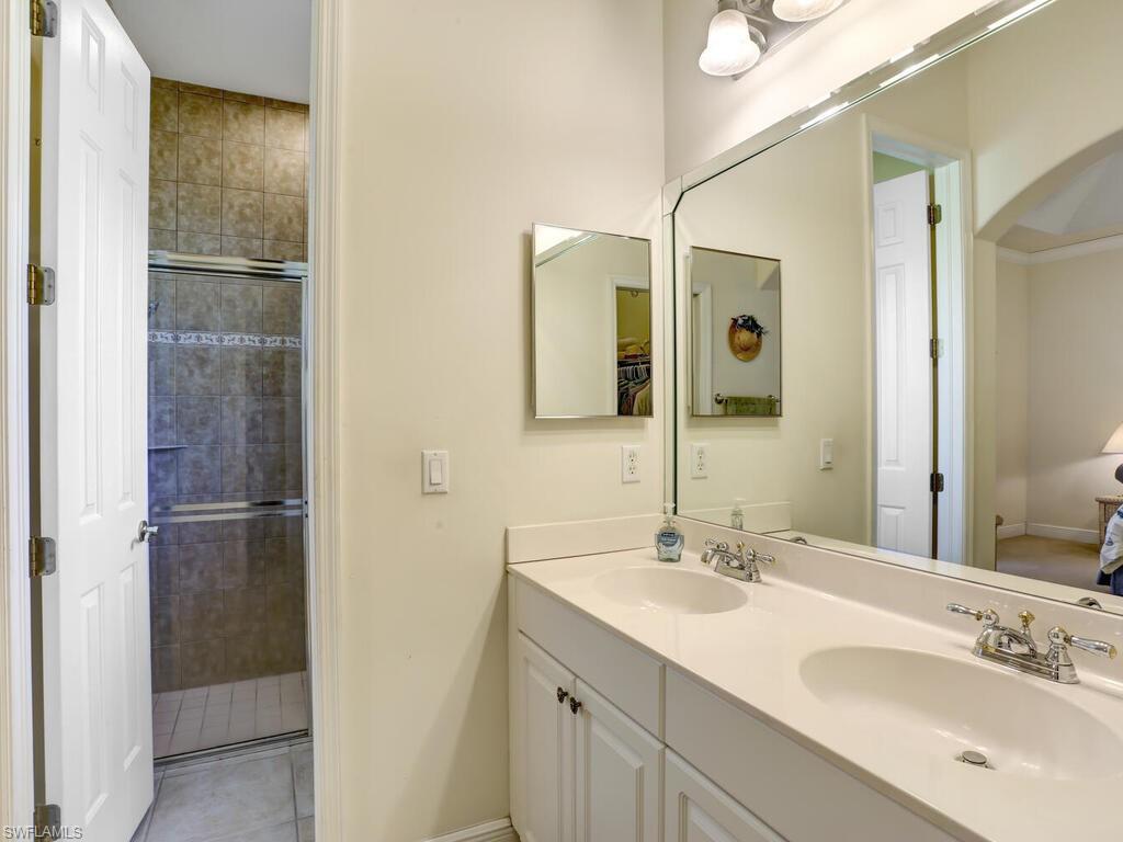 1079 Michigan Avenue Naples, FL 34103 - Photo 25 of 31 a bathroom with a double vanity sink and mirror