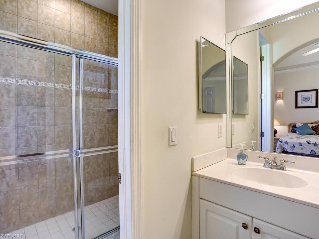 1079 Michigan Avenue Naples, FL 34103 - Photo 27 of 31 a bathroom with a sink and a mirror