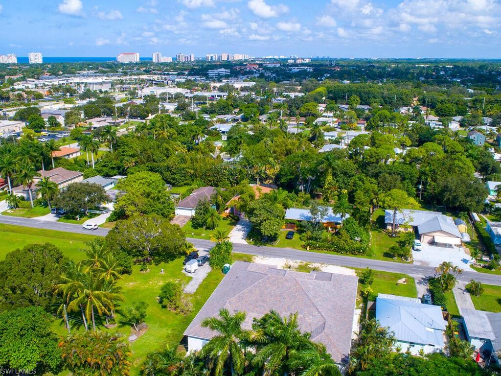 1079 Michigan Avenue Naples, FL 34103 - Photo 5 of 31 an aerial view of residential houses with outdoor space and trees