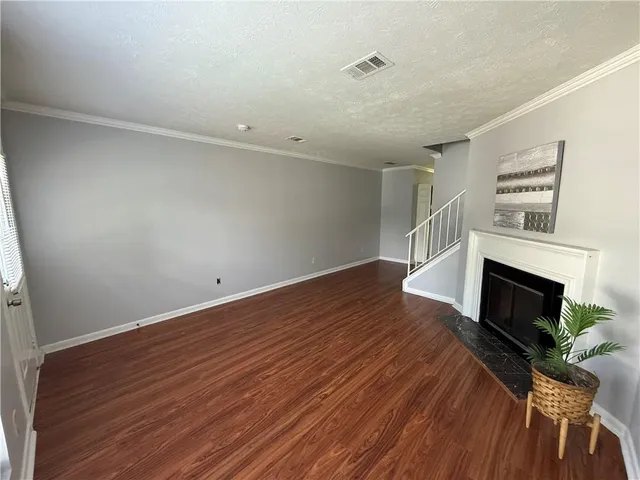 wooden floor in an empty room with a fireplace