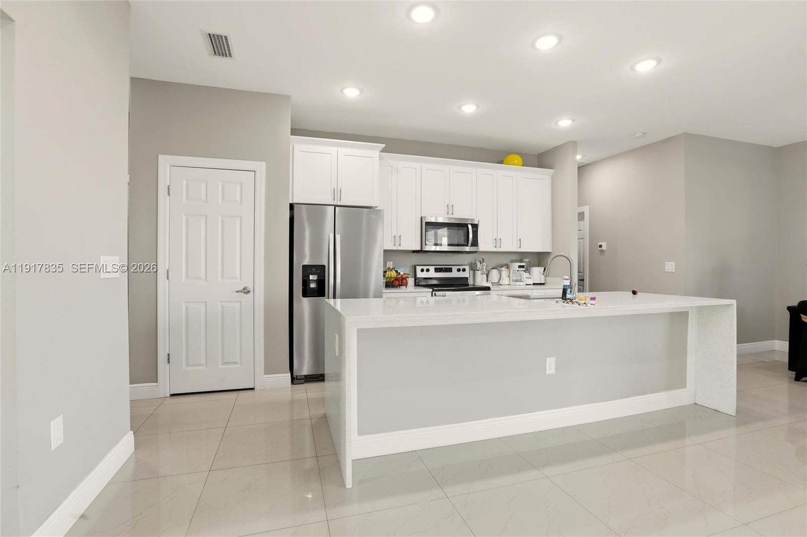 2908 9th Street Southwest Lehigh Acres, FL 33976 - Photo 13 of 44 a view of kitchen with stainless steel appliances granite countertop a refrigerator and a sink