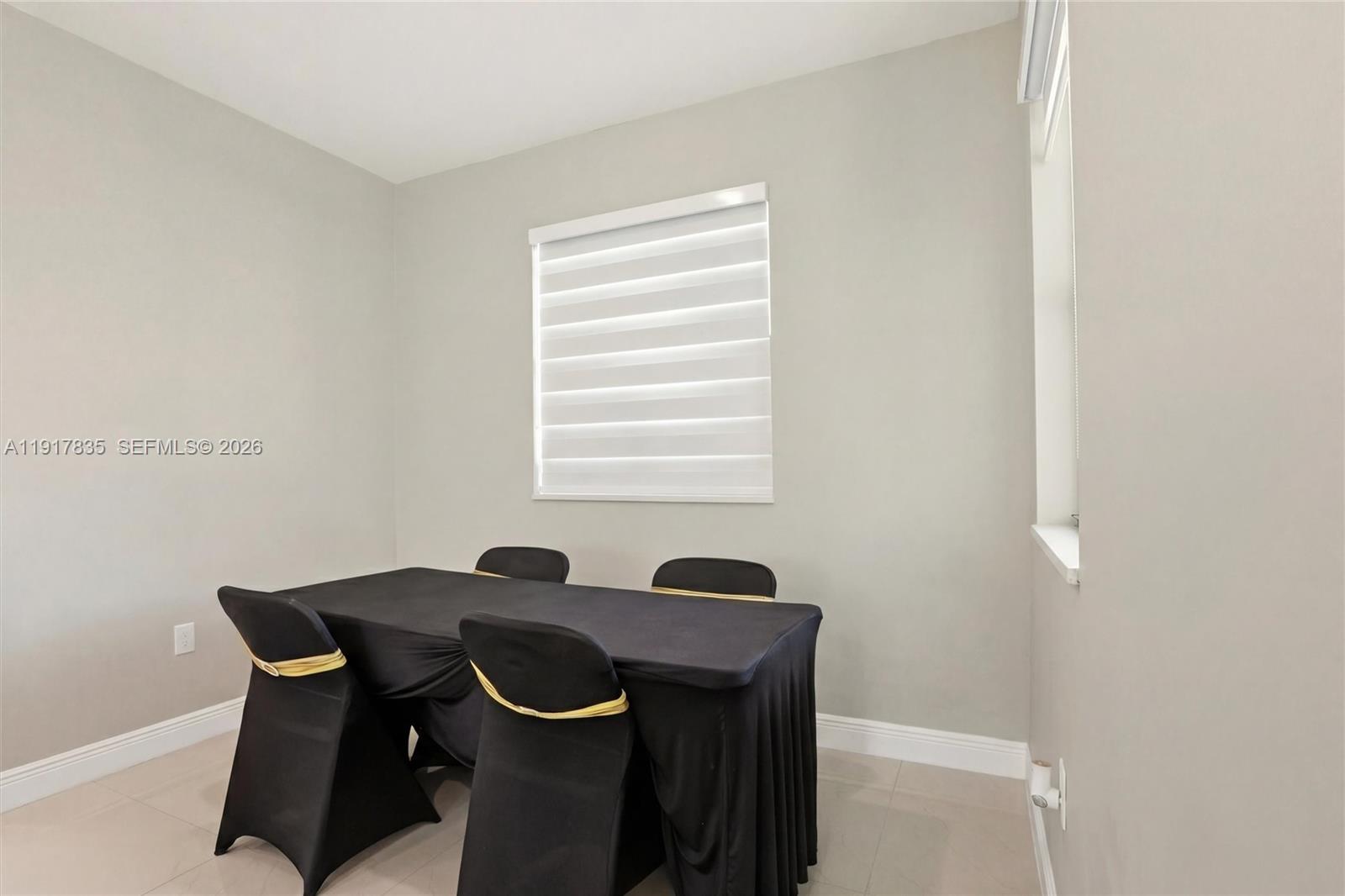 2908 9th Street Southwest Lehigh Acres, FL 33976 - Photo 14 of 44 a view of a dining room with a table and chairs