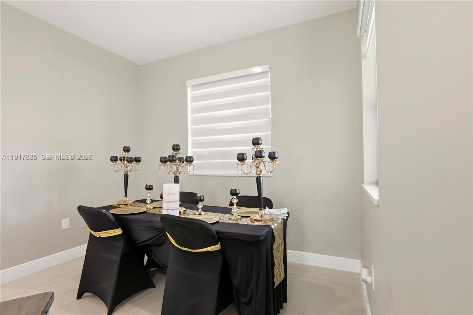 2908 9th Street Southwest Lehigh Acres, FL 33976 - Photo 15 of 44 a view of a dining room with furniture and window