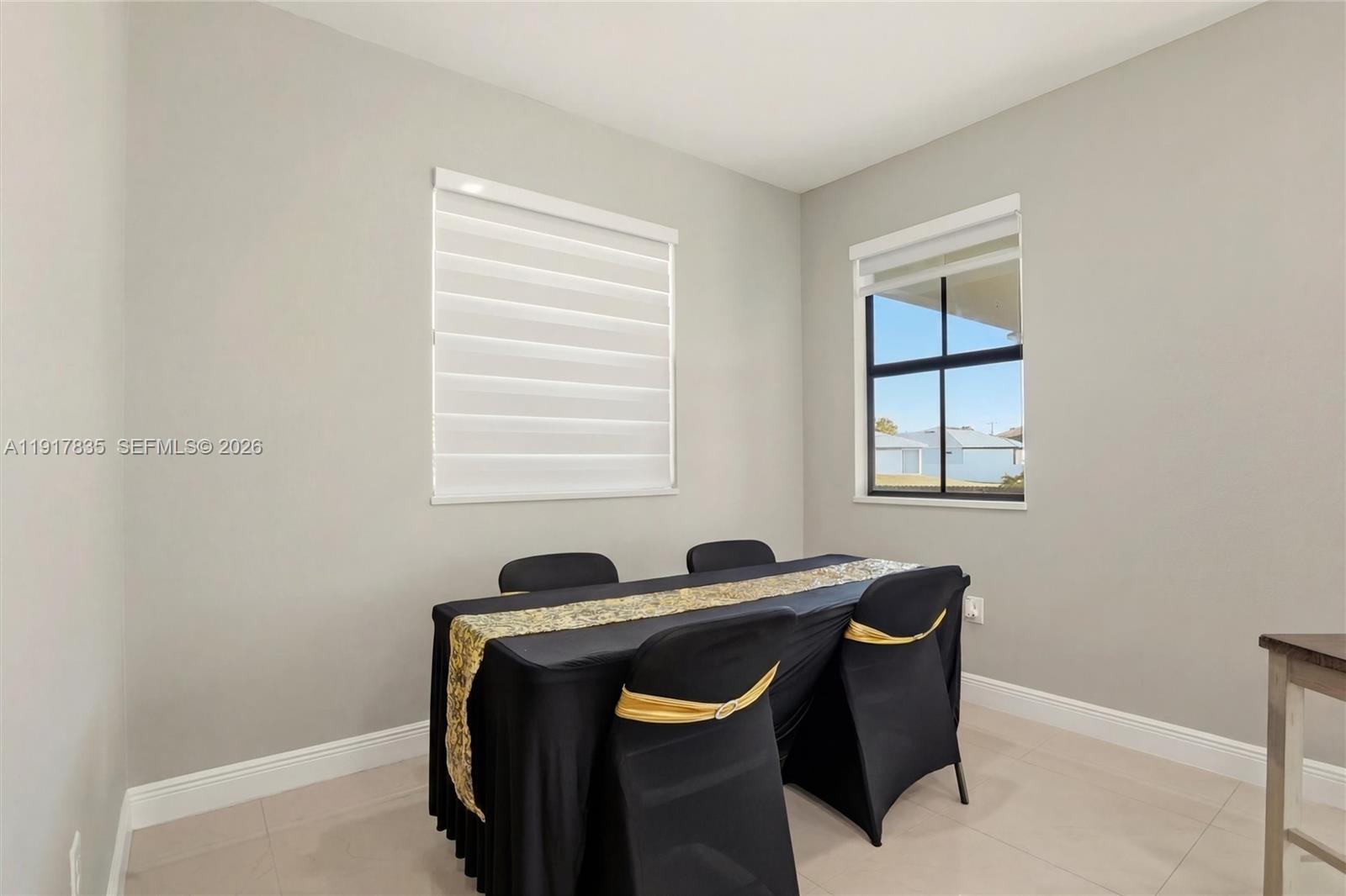 2908 9th Street Southwest Lehigh Acres, FL 33976 - Photo 16 of 44 a view of a workspace with furniture and a window