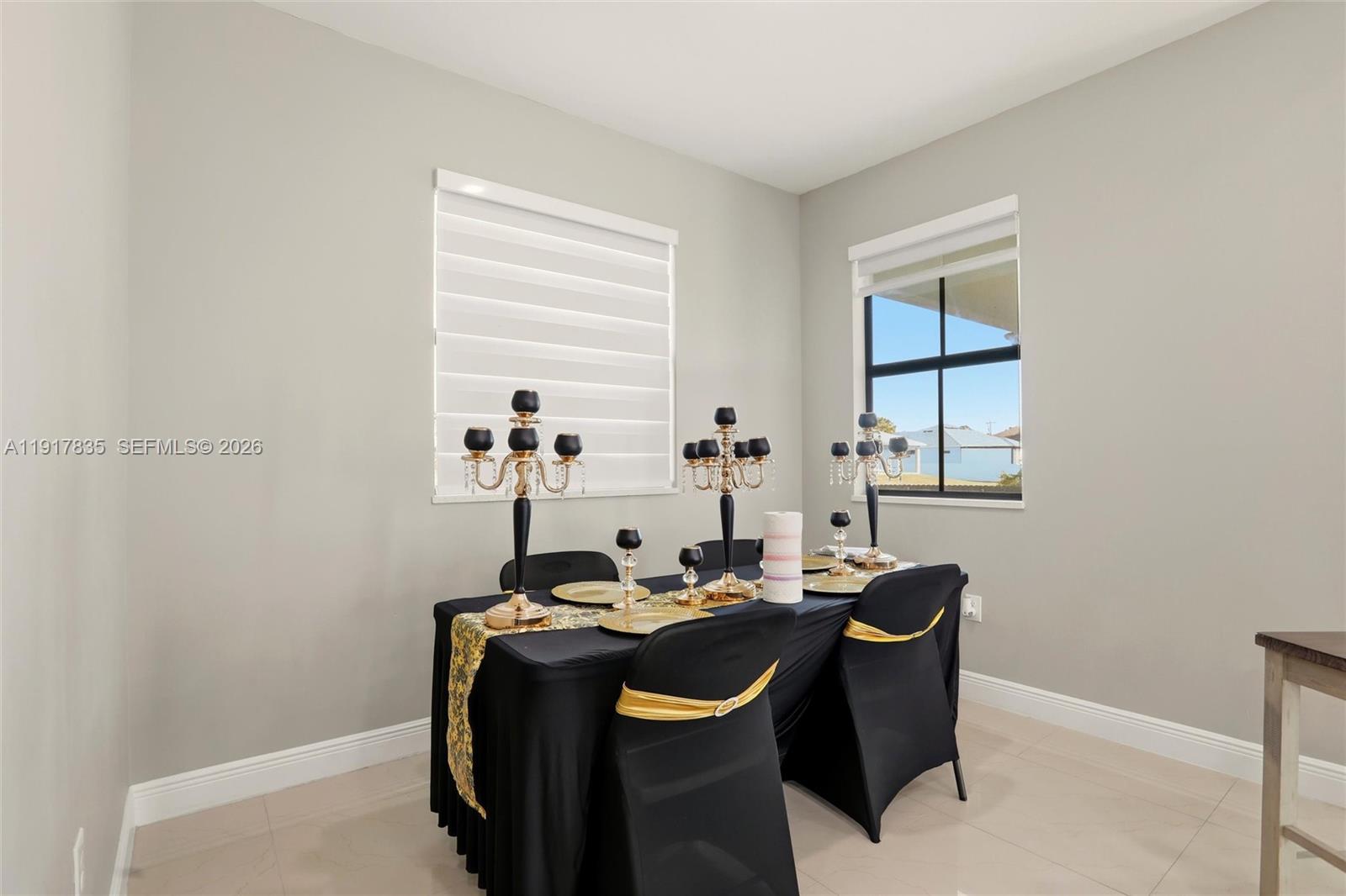 2908 9th Street Southwest Lehigh Acres, FL 33976 - Photo 17 of 44 a table and chairs in a room