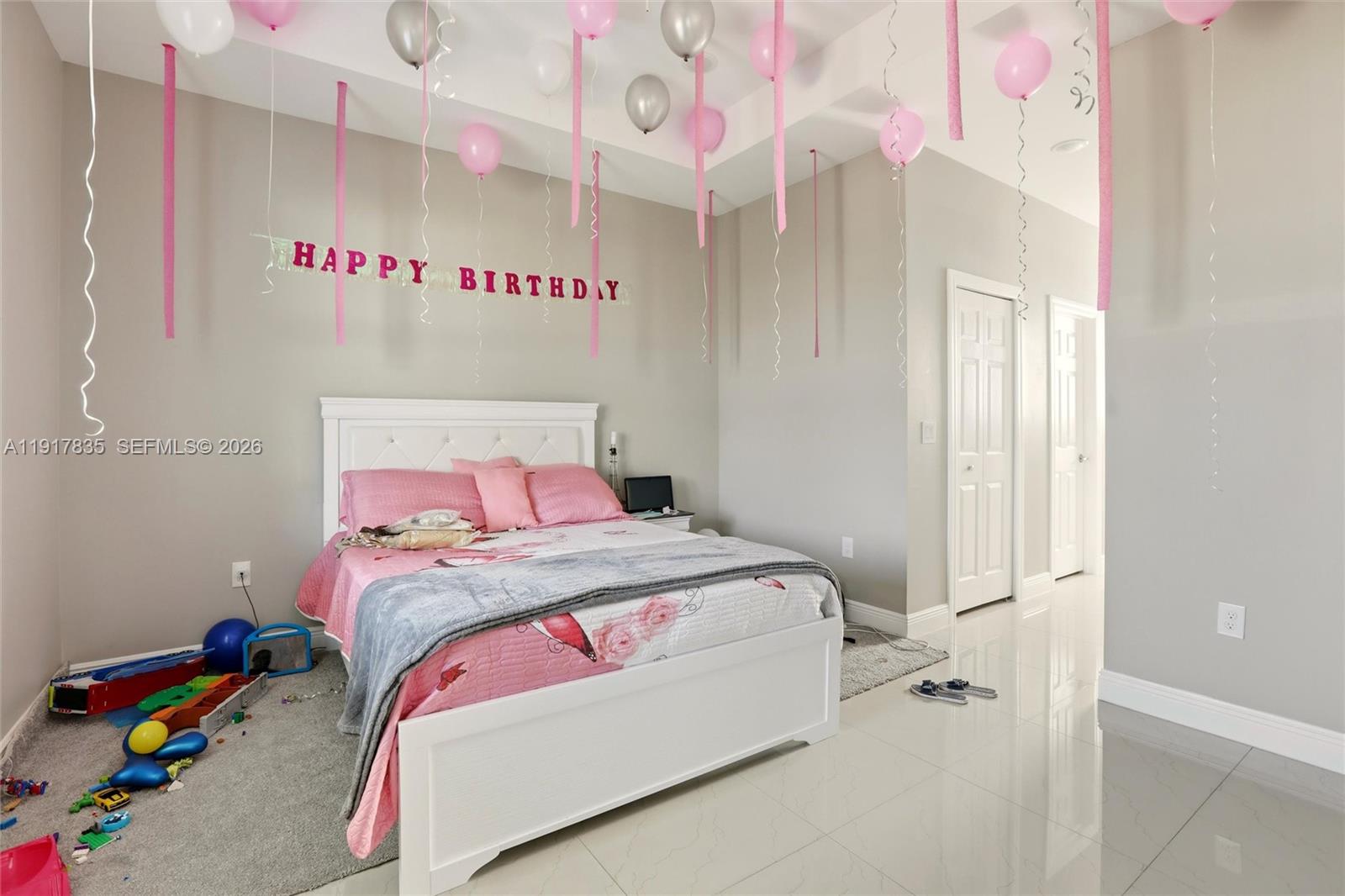 2908 9th Street Southwest Lehigh Acres, FL 33976 - Photo 19 of 44 a bedroom with a bed and a window