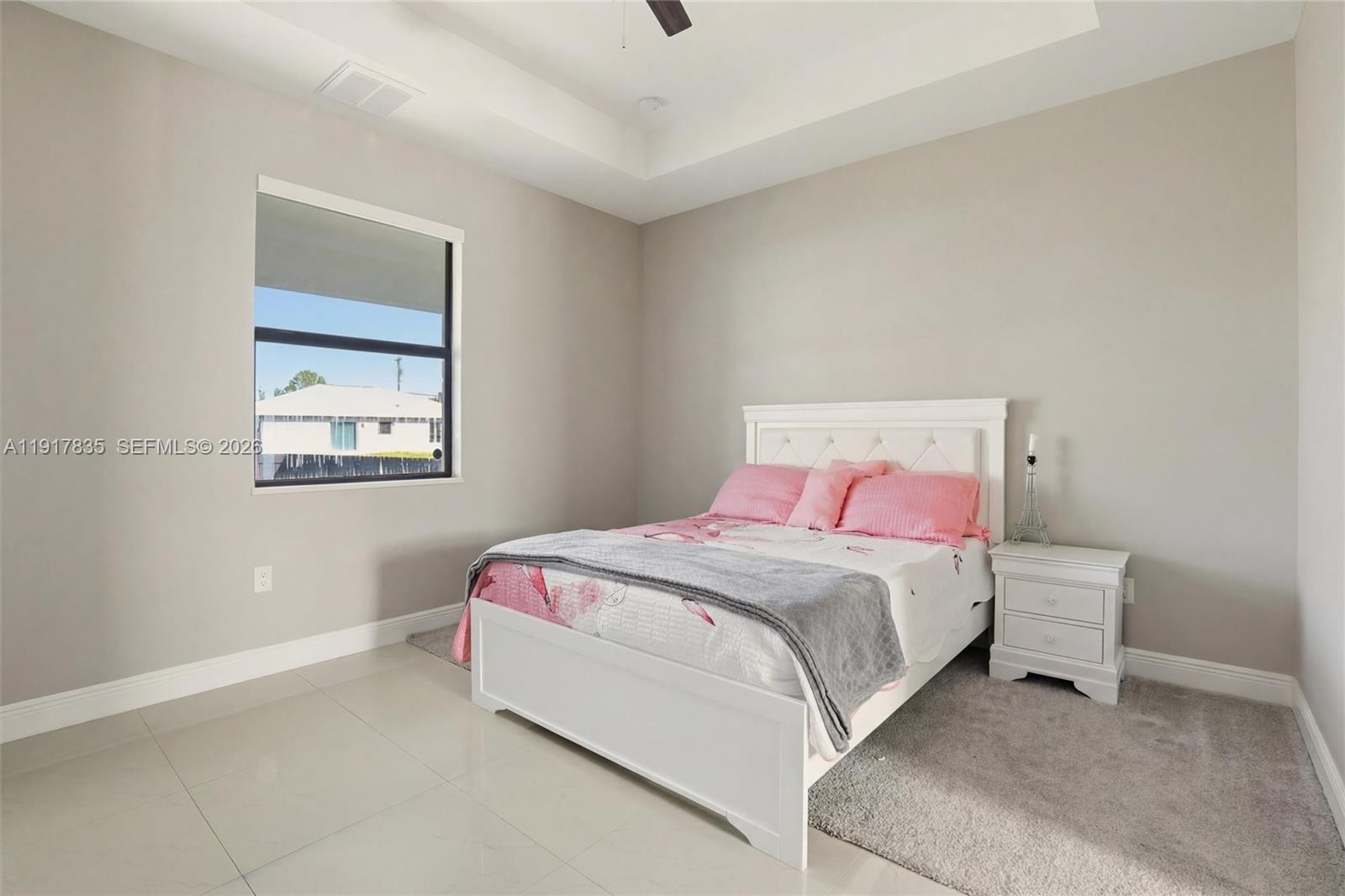 2908 9th Street Southwest Lehigh Acres, FL 33976 - Photo 20 of 44 a bedroom with a bed and a lamp