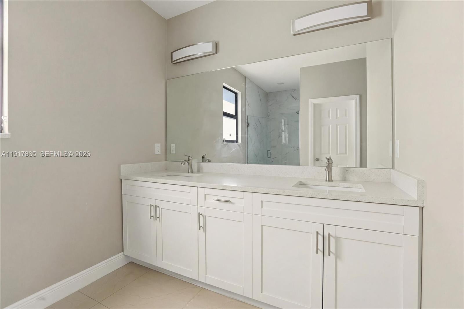 2908 9th Street Southwest Lehigh Acres, FL 33976 - Photo 21 of 44 a bathroom with a sink and a mirror