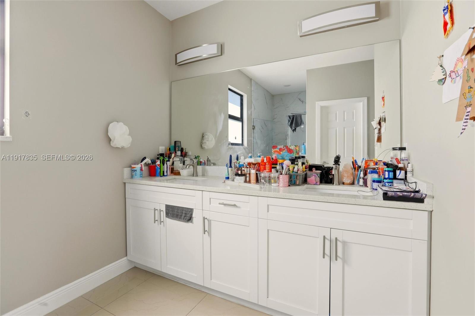 2908 9th Street Southwest Lehigh Acres, FL 33976 - Photo 22 of 44 a bathroom with a sink and a mirror