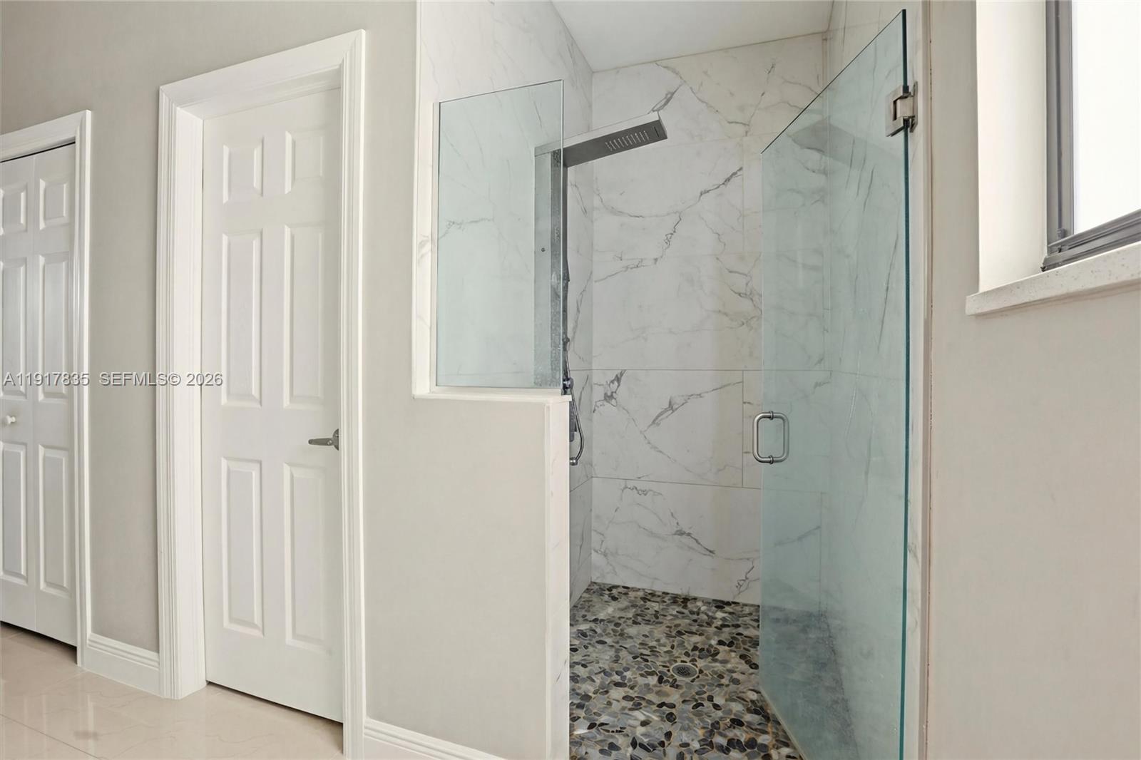 2908 9th Street Southwest Lehigh Acres, FL 33976 - Photo 23 of 44 a bathroom with a shower