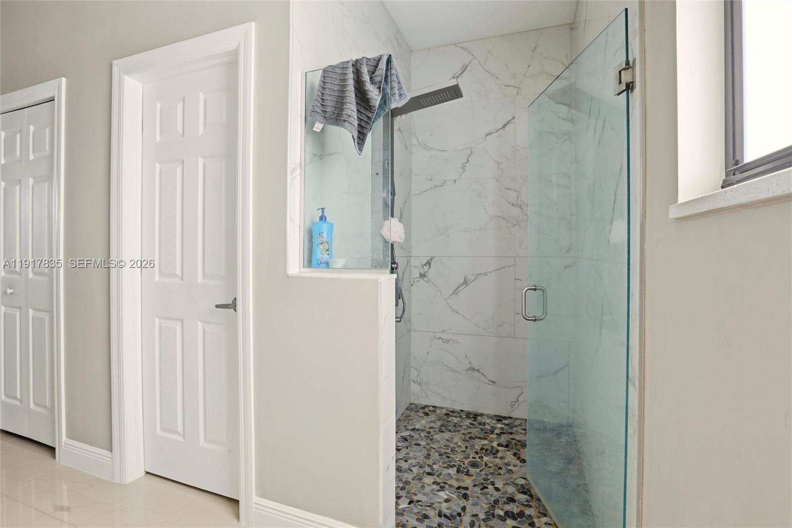 2908 9th Street Southwest Lehigh Acres, FL 33976 - Photo 24 of 44 a bathroom with a shower