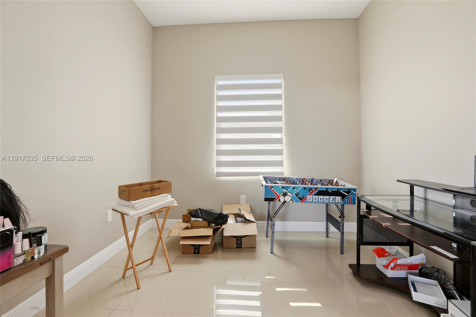 2908 9th Street Southwest Lehigh Acres, FL 33976 - Photo 26 of 44 a living room with furniture a flat screen tv and a window