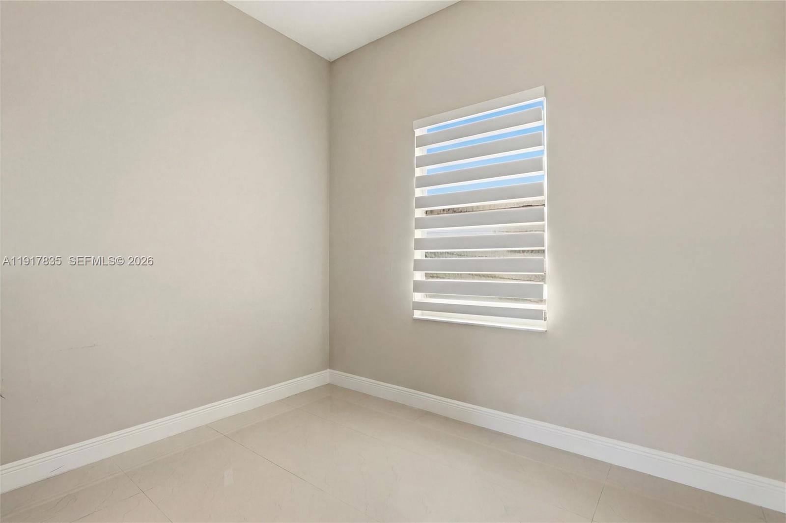 2908 9th Street Southwest Lehigh Acres, FL 33976 - Photo 27 of 44 a room that has a window in it