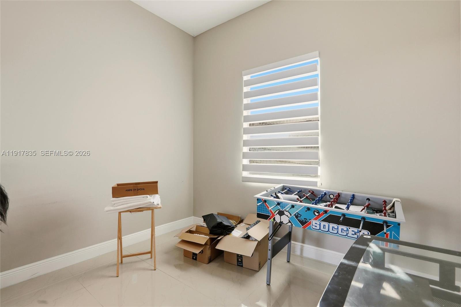 2908 9th Street Southwest Lehigh Acres, FL 33976 - Photo 28 of 44 a room with furniture and a window