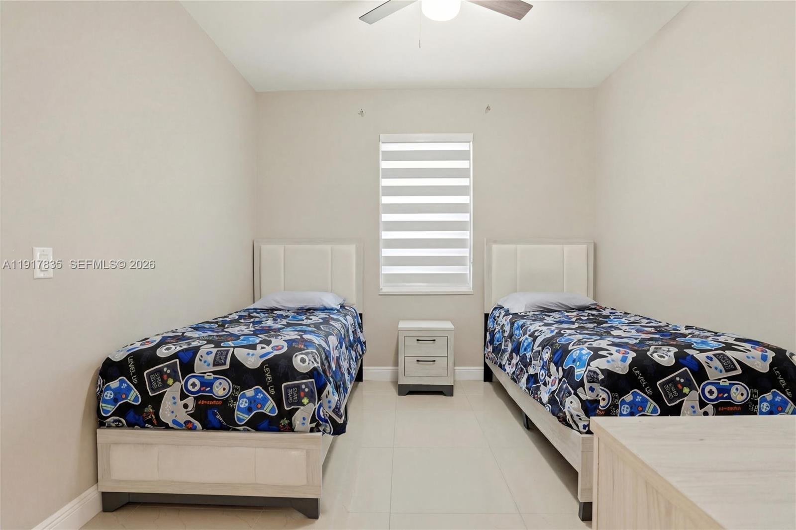 2908 9th Street Southwest Lehigh Acres, FL 33976 - Photo 29 of 44 a bedroom with two beds and a window