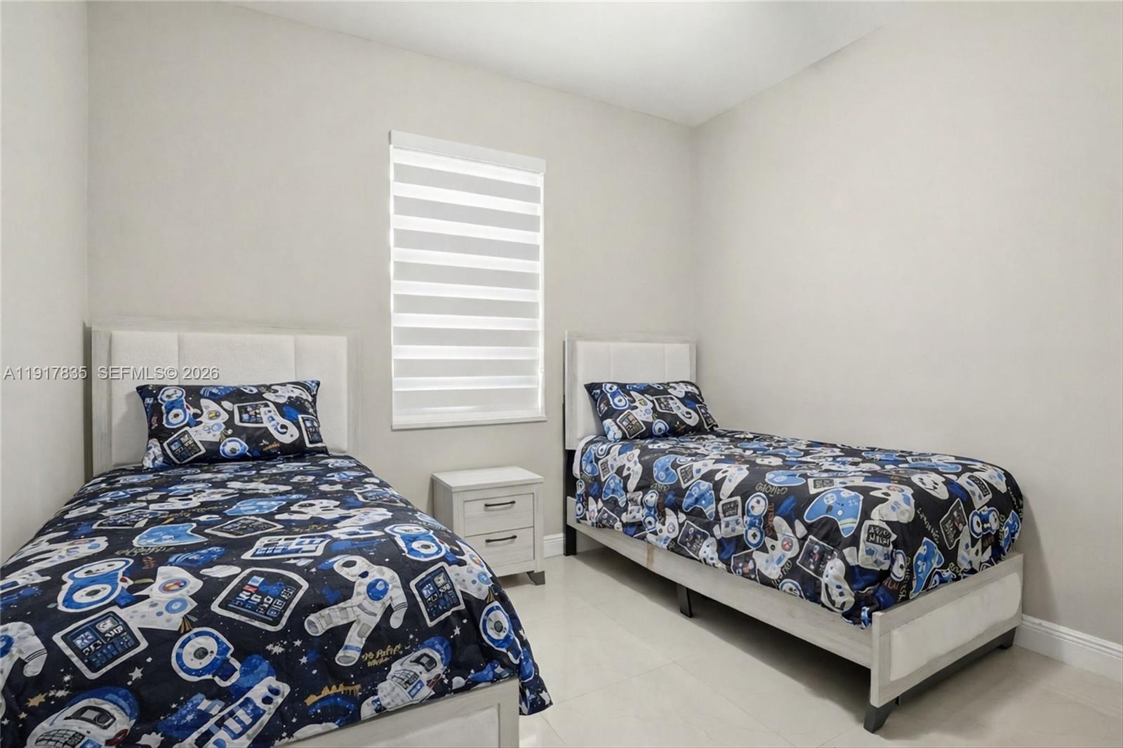 2908 9th Street Southwest Lehigh Acres, FL 33976 - Photo 31 of 44 a bedroom with a bed and window