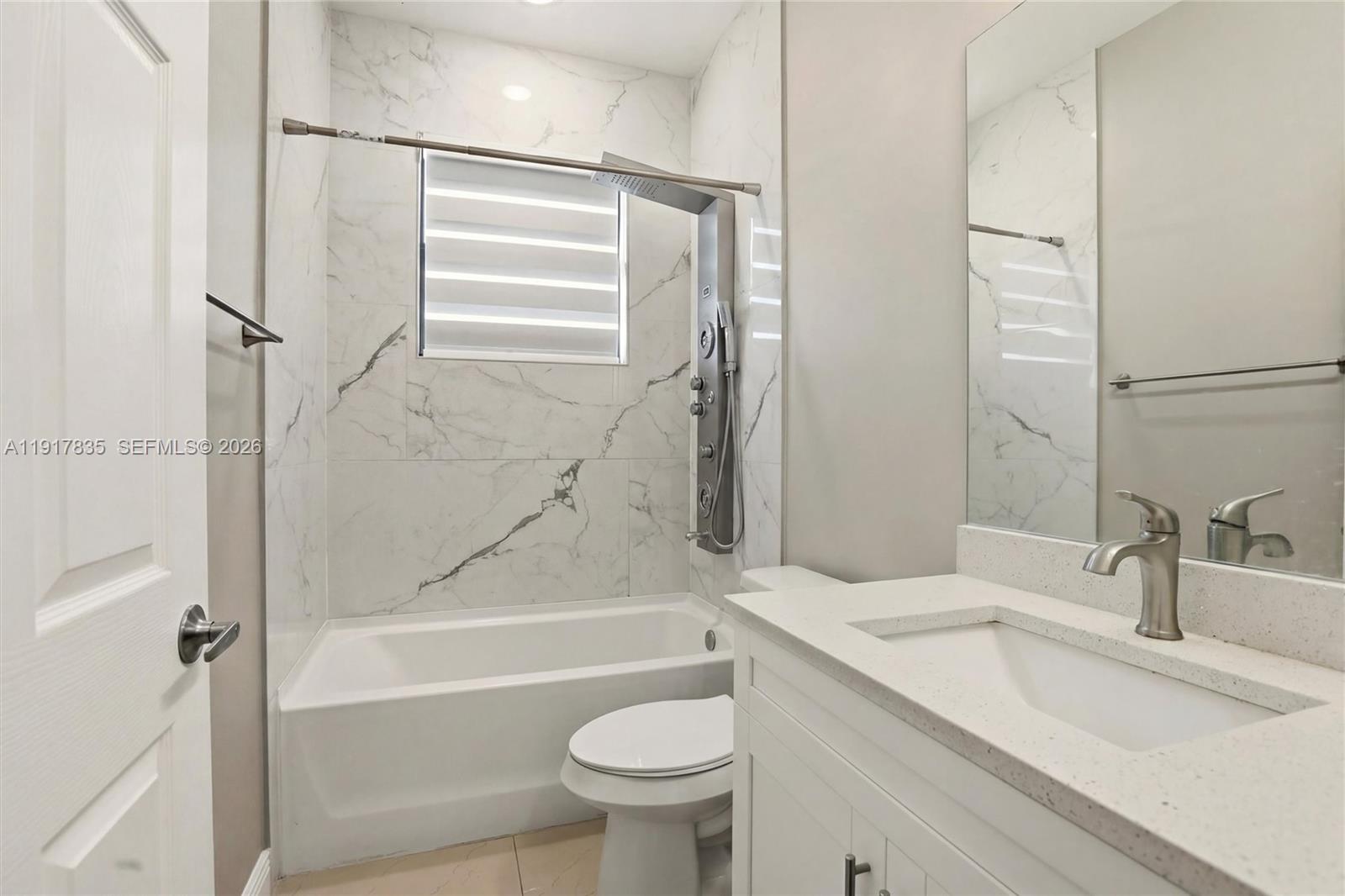 2908 9th Street Southwest Lehigh Acres, FL 33976 - Photo 33 of 44 a bathroom with a sink toilet and shower