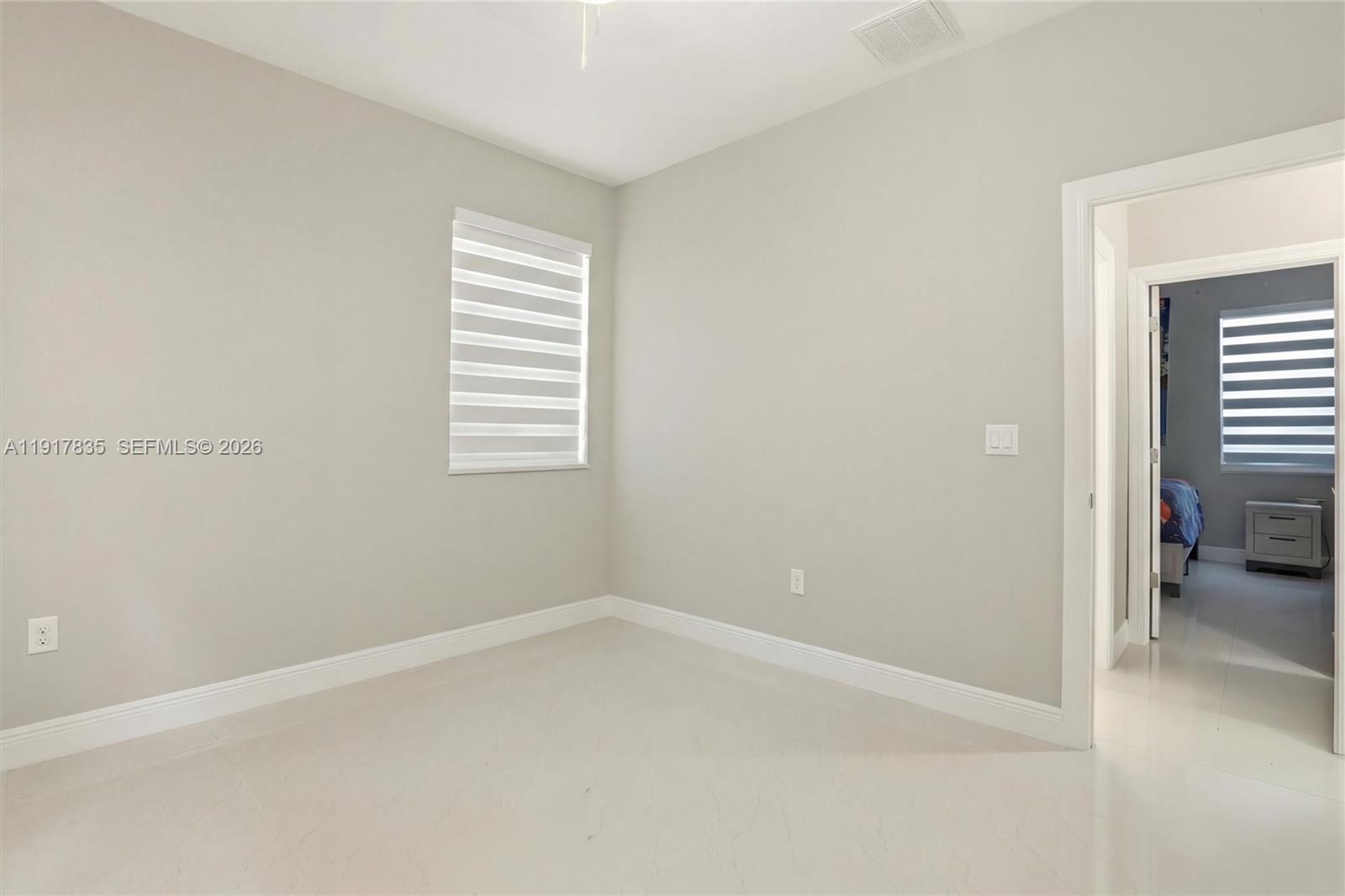 2908 9th Street Southwest Lehigh Acres, FL 33976 - Photo 37 of 44 an empty room with windows and closet