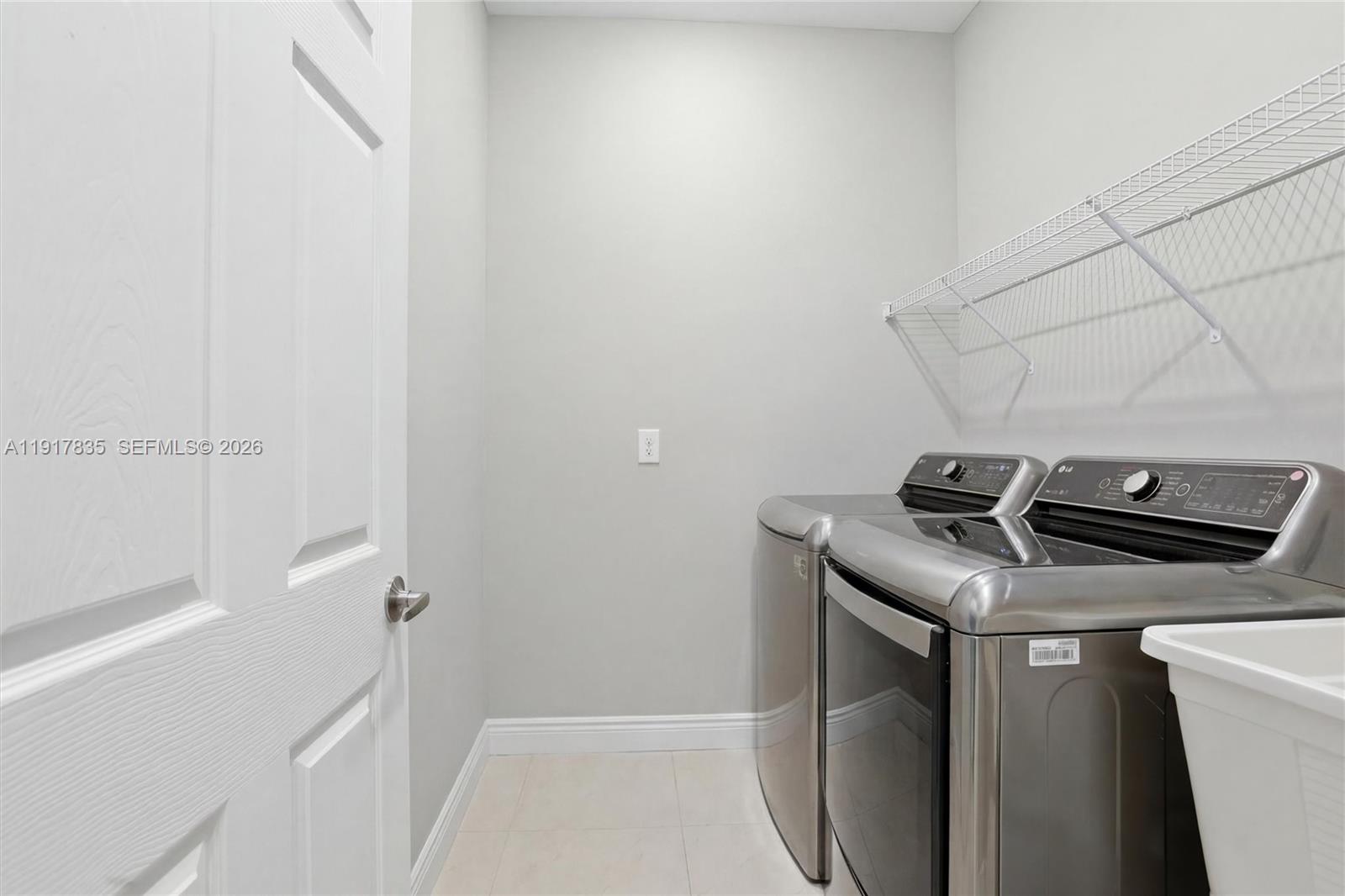 2908 9th Street Southwest Lehigh Acres, FL 33976 - Photo 39 of 44 a utility room with dryer and washer