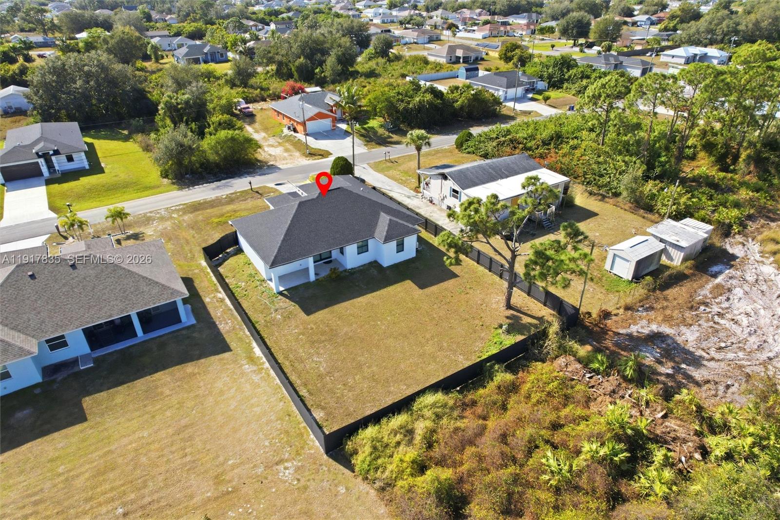 2908 9th Street Southwest Lehigh Acres, FL 33976 - Photo 43 of 44 an aerial view of residential houses with outdoor space