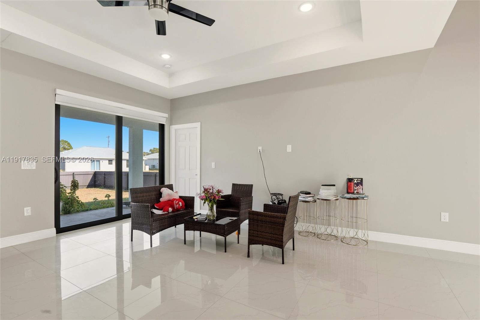 2908 9th Street Southwest Lehigh Acres, FL 33976 - Photo 5 of 44 a dining room with furniture and a floor to ceiling window