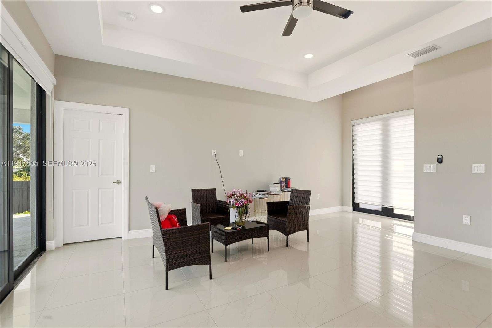 2908 9th Street Southwest Lehigh Acres, FL 33976 - Photo 7 of 44 a living room with furniture and a ceiling fan