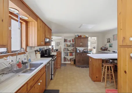 a kitchen with a sink stove and cabinets