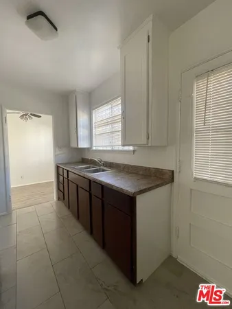 a kitchen with stainless steel appliances granite countertop a sink and a stove