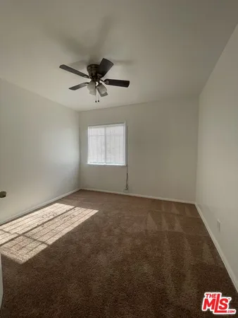 a view of an empty room and a window