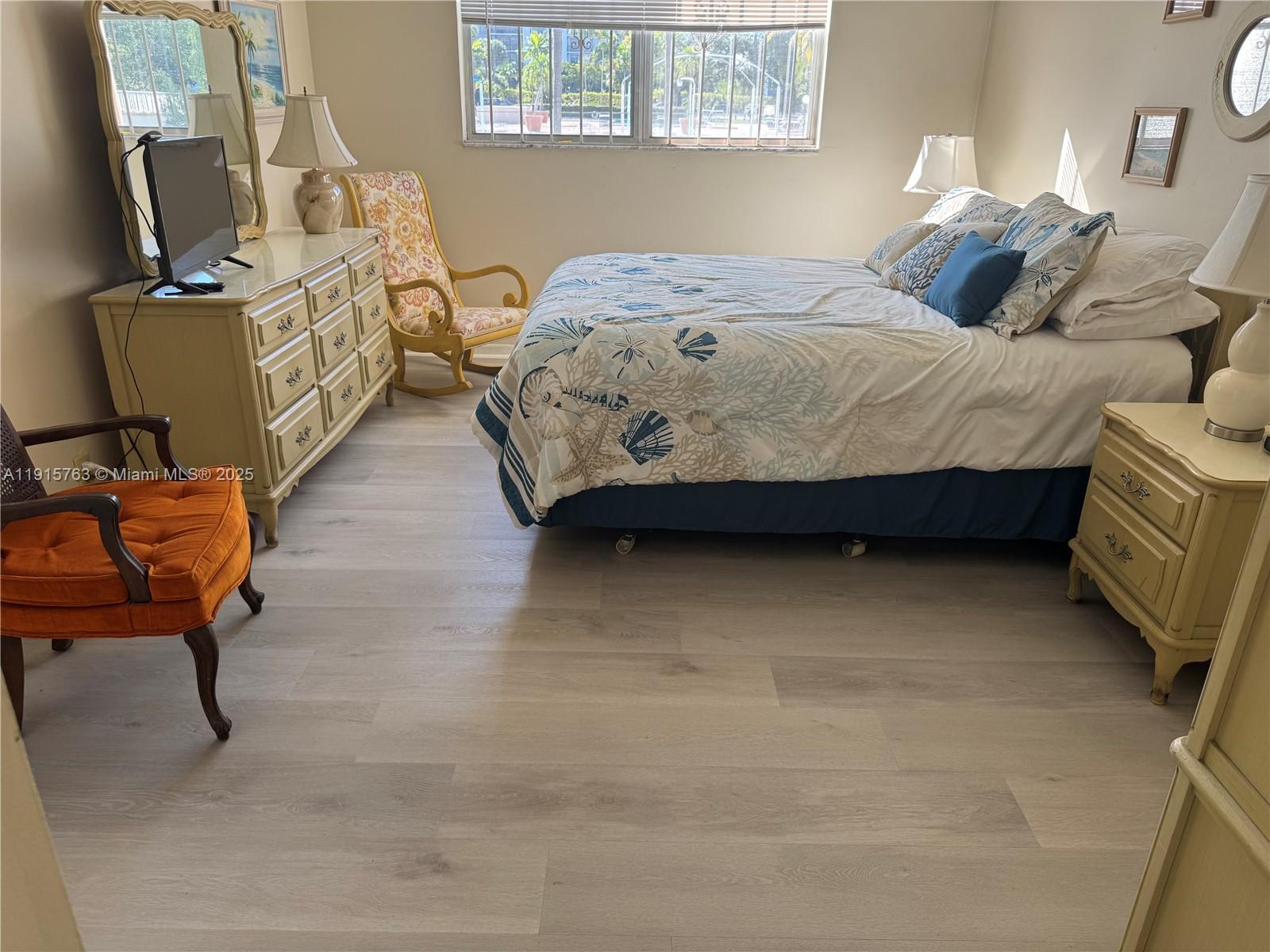 505 East Dania Beach Boulevard, Unit 41K Dania Beach, FL 33004 - Photo 11 of 22 a bedroom with a bed and wooden floor