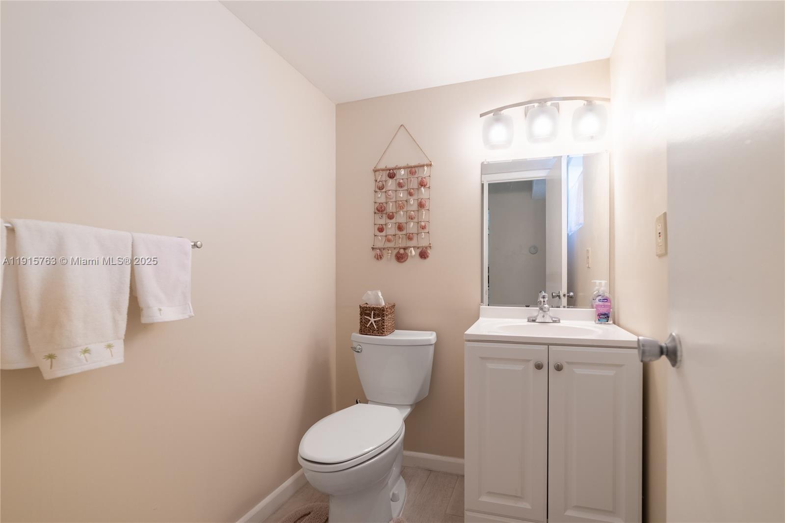 505 East Dania Beach Boulevard, Unit 41K Dania Beach, FL 33004 - Photo 14 of 22 a bathroom with a toilet sink and mirror