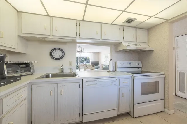 a kitchen with refrigerator and cabinets