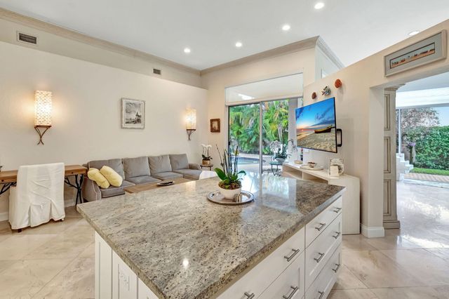 a kitchen with granite countertop a sink and a large window