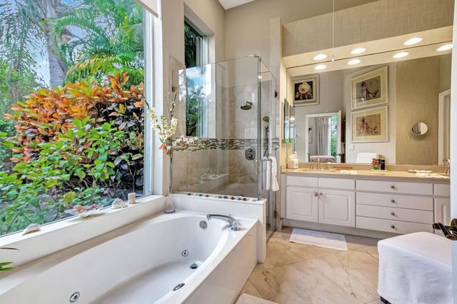 a bathroom with a bathtub sink and mirror