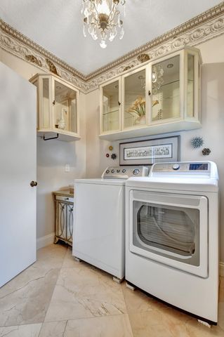 a utility room with stainless steel appliances granite countertop a stove and a refrigerator