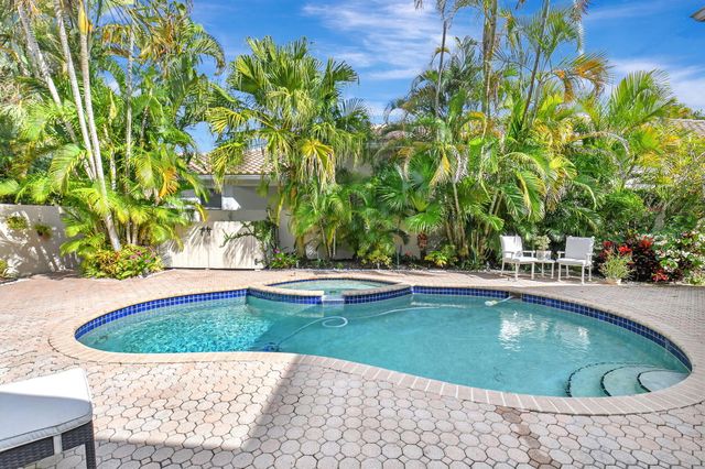 a view of a swimming pool with a yard