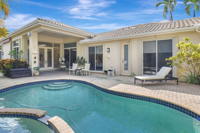 a view of a house with swimming pool and porch with furniture