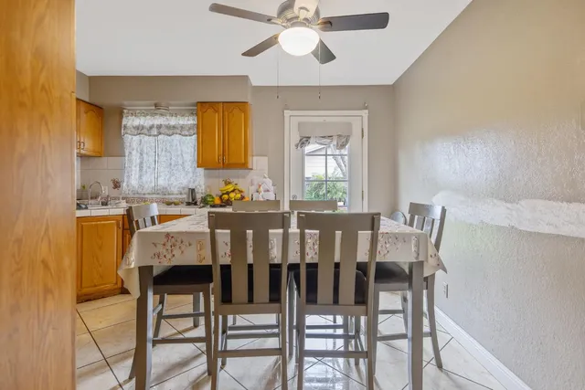 a view of a dining room with furniture and a chandelier