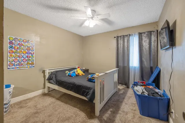 a bedroom with a bed and a chandelier