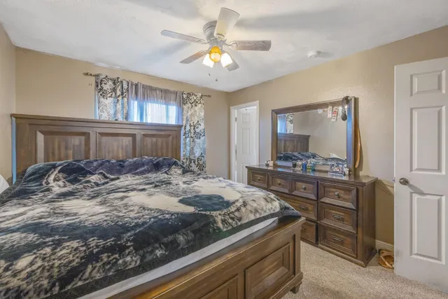 a bedroom with a large bed and a chandelier