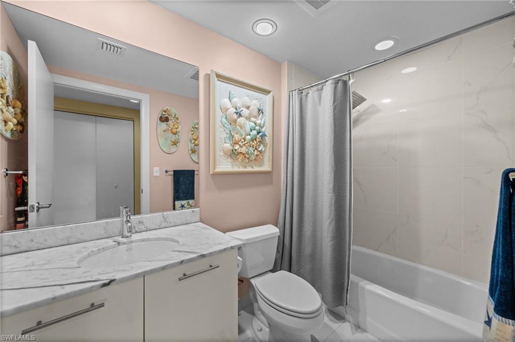 3000 Oasis Grand Boulevard, Unit 2702 Fort Myers, FL 33916 - Photo 12 of 34 a bathroom with a granite countertop sink toilet and shower