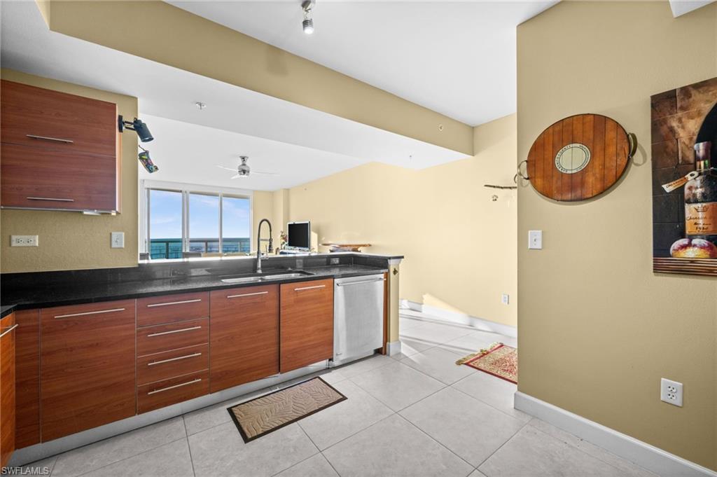 3000 Oasis Grand Boulevard, Unit 2702 Fort Myers, FL 33916 - Photo 15 of 34 a kitchen with stainless steel appliances granite countertop a sink and a stove
