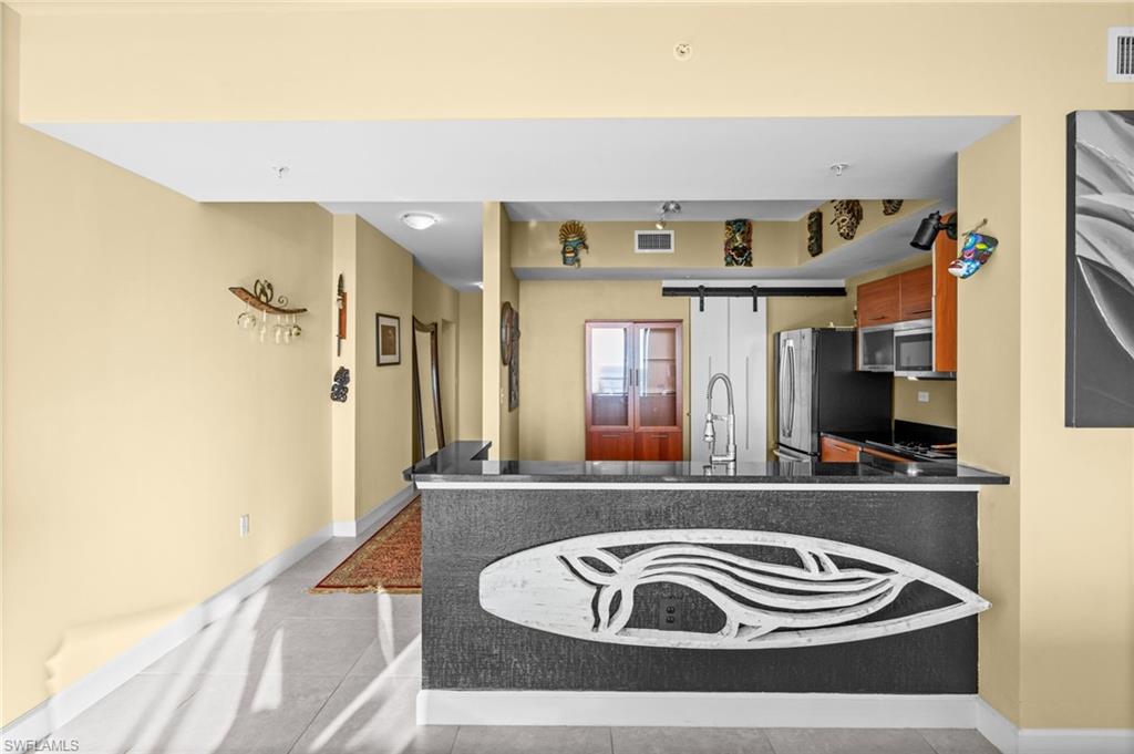 3000 Oasis Grand Boulevard, Unit 2702 Fort Myers, FL 33916 - Photo 16 of 34 a view of kitchen and a living room