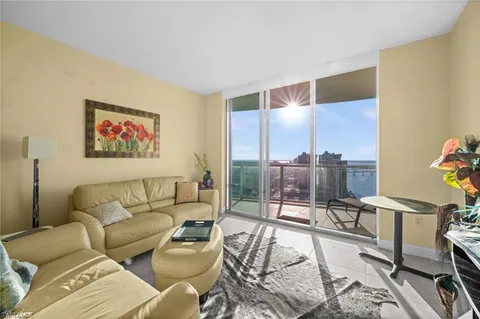 a living room with furniture and a floor to ceiling window