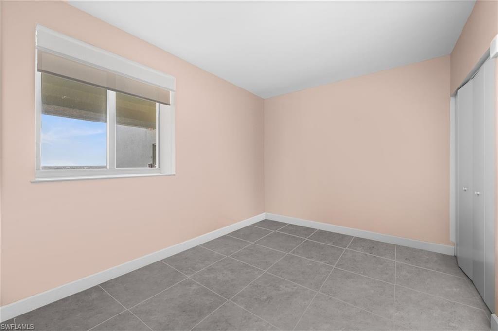 3000 Oasis Grand Boulevard, Unit 2702 Fort Myers, FL 33916 - Photo 27 of 34 an empty room with a window
