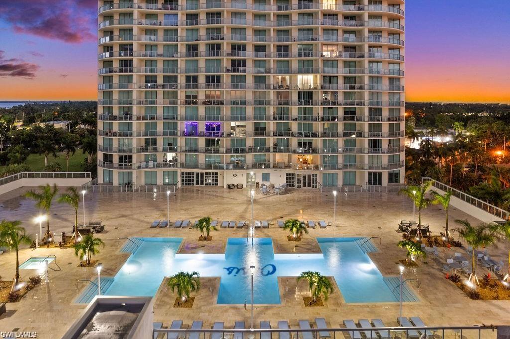 3000 Oasis Grand Boulevard, Unit 2702 Fort Myers, FL 33916 - Photo 29 of 34 a view of swimming pool with outdoor seating