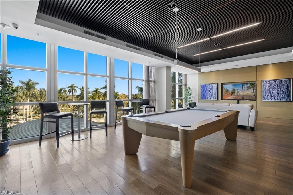 3000 Oasis Grand Boulevard, Unit 2702 Fort Myers, FL 33916 - Photo 30 of 34 a open kitchen with stainless steel appliances granite countertop a stove and cabinets