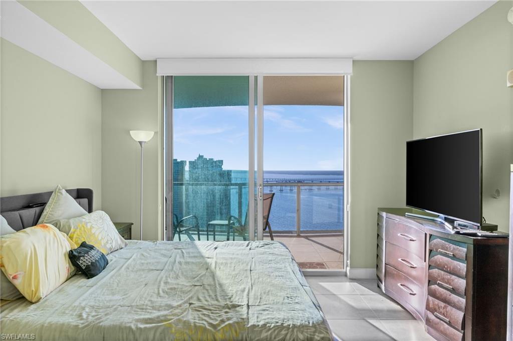 3000 Oasis Grand Boulevard, Unit 2702 Fort Myers, FL 33916 - Photo 4 of 34 a bedroom with a bed and a flat screen tv