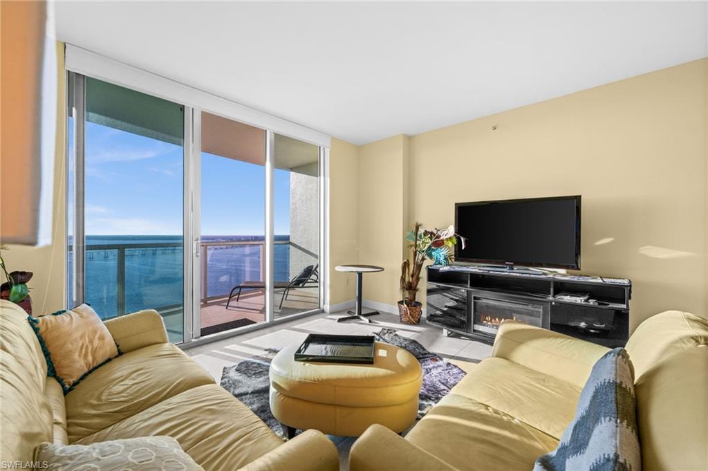 3000 Oasis Grand Boulevard, Unit 2702 Fort Myers, FL 33916 - Photo 6 of 34 a living room with furniture and a flat screen tv