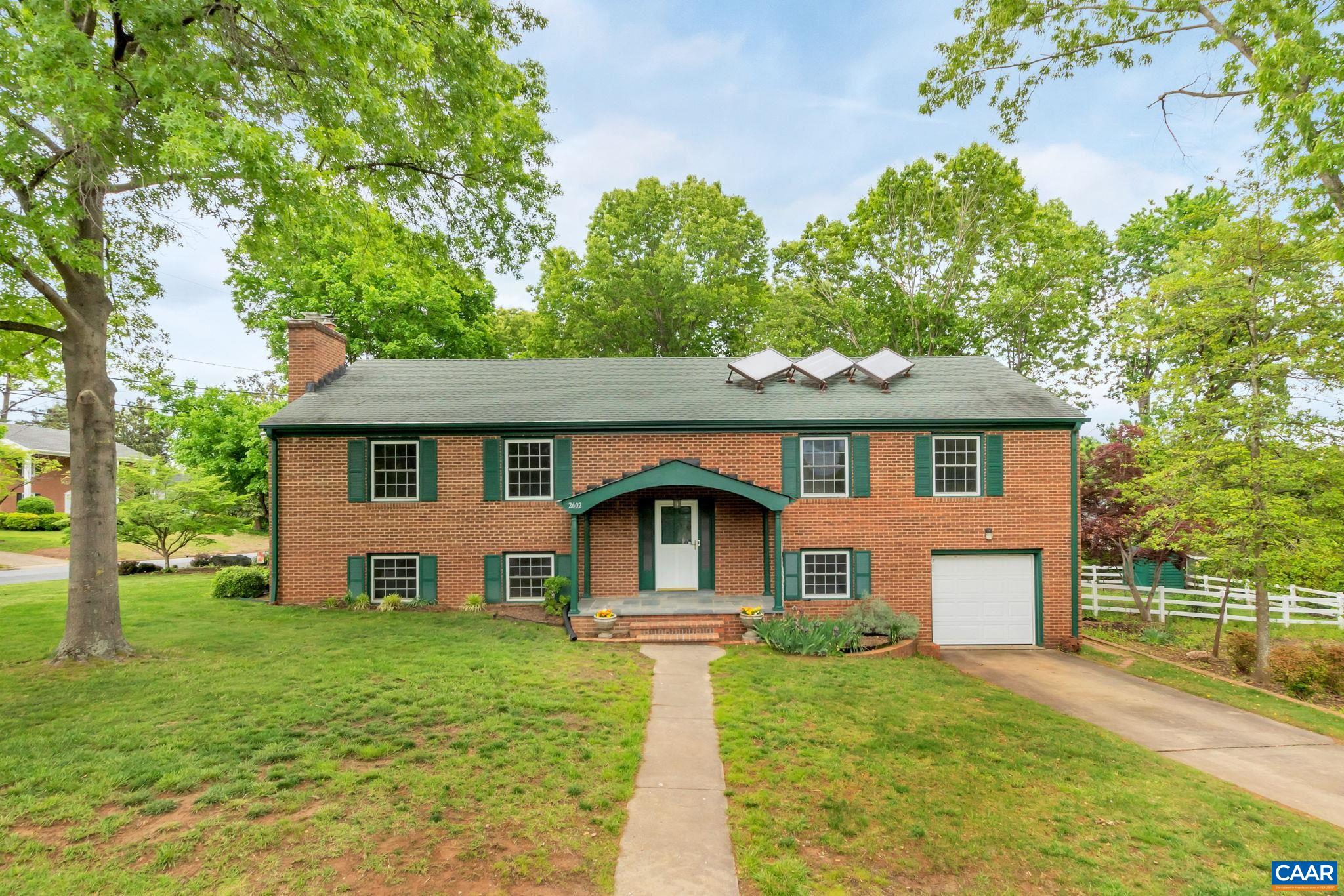 2602 Bennington Road Charlottesville, VA 22901 - Photo 1 of 50 a front view of a house with a yard and trees
